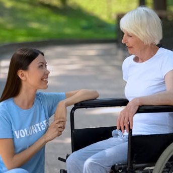 A caregiver helping a woman in a wheelchair