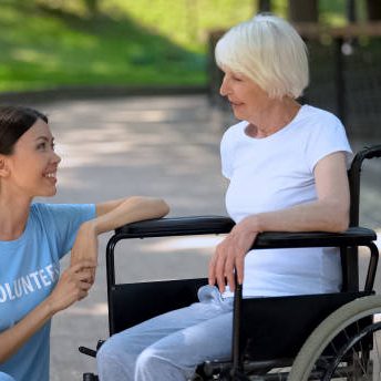 A caregiver helping a woman in a wheelchair