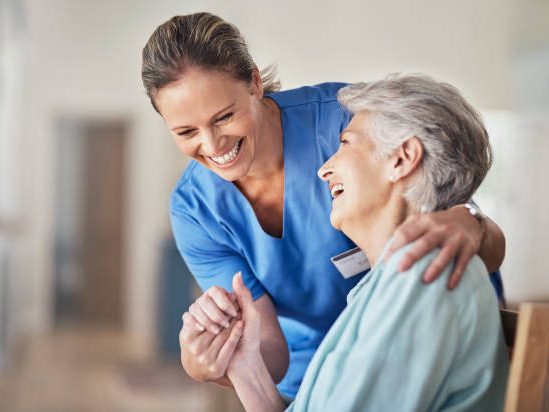 A nurse enjoying a moment with the patient image